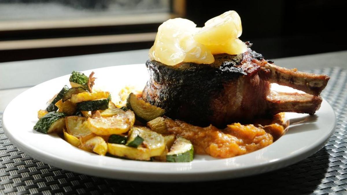 A double bone pork chop topped with apples was one of the items at the Upstart Crow on West Short Street. The restaurant closed recently after being open about a year.