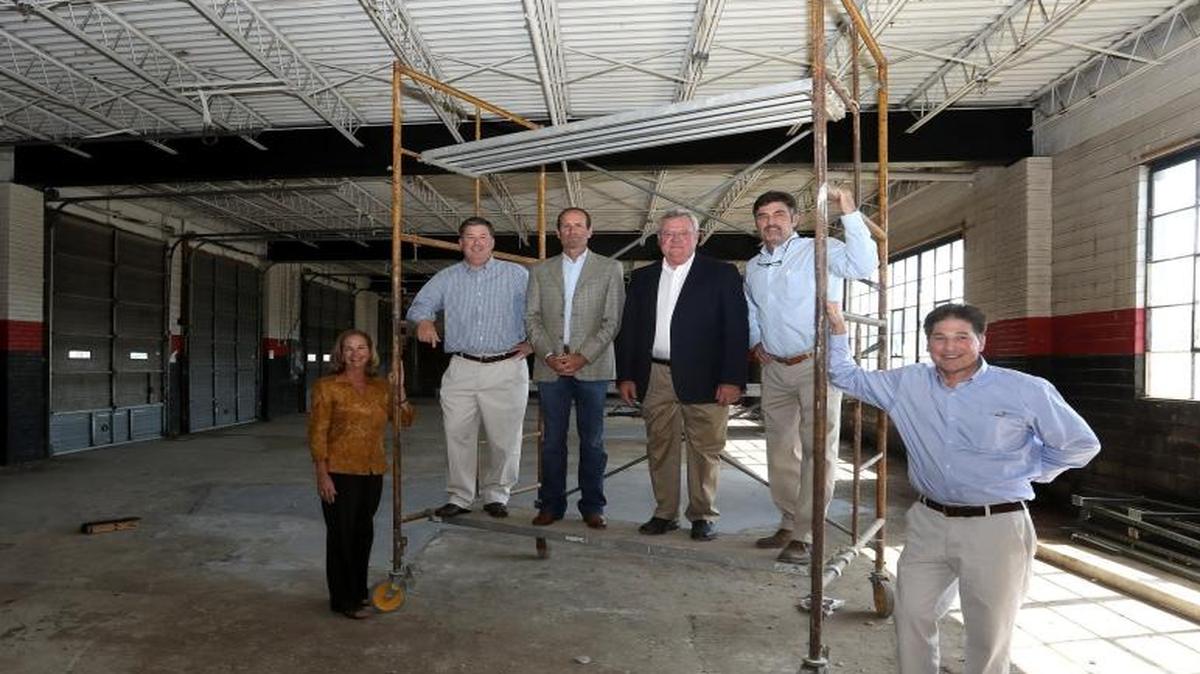 Partners Shelly Gaffney, left, David Henry, John Hampton, Russ Griffith and Jim McCarty are utilizing the skill of architect Tom Cheek, right, to transform this former garage at 780 Winchester Road into the new home of Griffith Catlett Hampton Insurance on Winchester Road.
