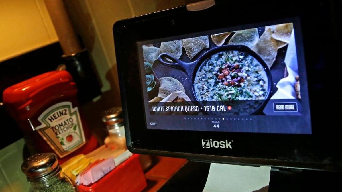 A Ziosk tablet displays an appetizer a customer can order at a Chili's restaurant in Andover, Mass. Restaurant chains are making it easier to order food with a few taps of the screen, so much so that you may lose sight of how much you’re spending.