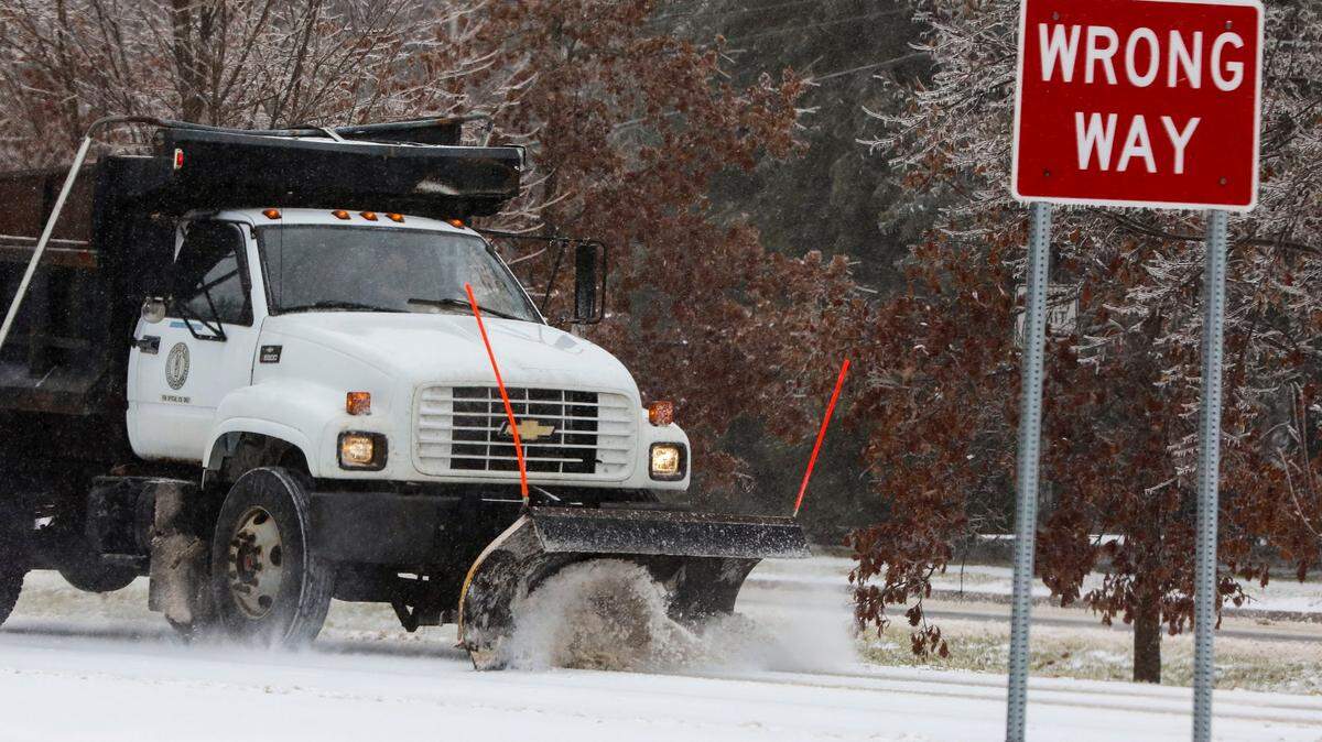 A Kentucky Department of Transportation snow plow clears Tates Creek Road at Alumni Drive in Lexington, Ky. Friday morning, Feb. 4, 2022 after an overnight winter storm of ice, sleet and snow blanketed the city.