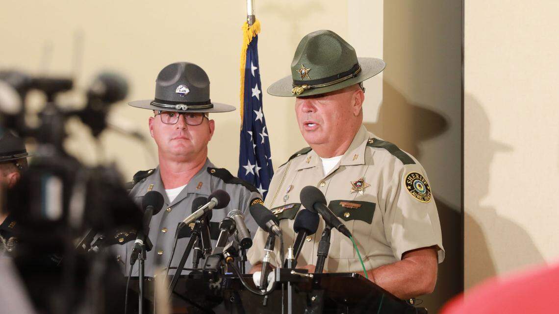 Kentucky State Police Trooper Scottie Pennington shares the podium with Laurel County Sheriff John Root at a news conference at the London County Community Center Sept. 10, 2024, in London, Ky. 