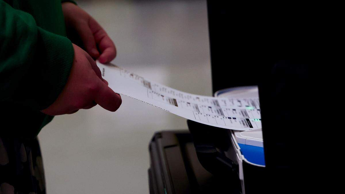 A voter puts their ballot into a scanner, casting their vote for the 2024 General Election in this file photo. Why doesn’t Kentucky have any elections in 2025?