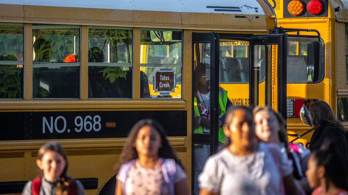 Students and parents arrive for the first day of school at Northern Elementary School in Lexington, Ky., on Wednesday, Aug. 16, 2023.  