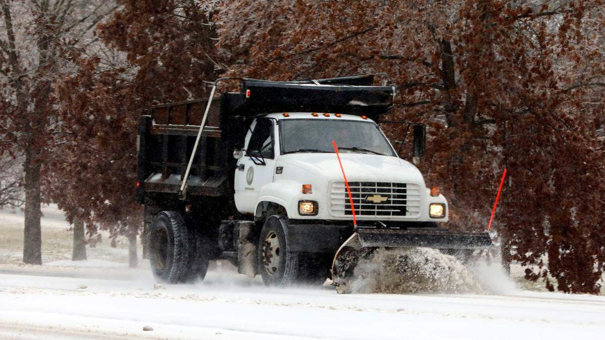 A Kentucky Department of Transportation snow plow clears Tates Creek Road at Alumni Drive in Lexington, Ky. Friday morning, Feb. 4, 2022 after an overnight winter storm of ice, sleet and snow blanketed the city.