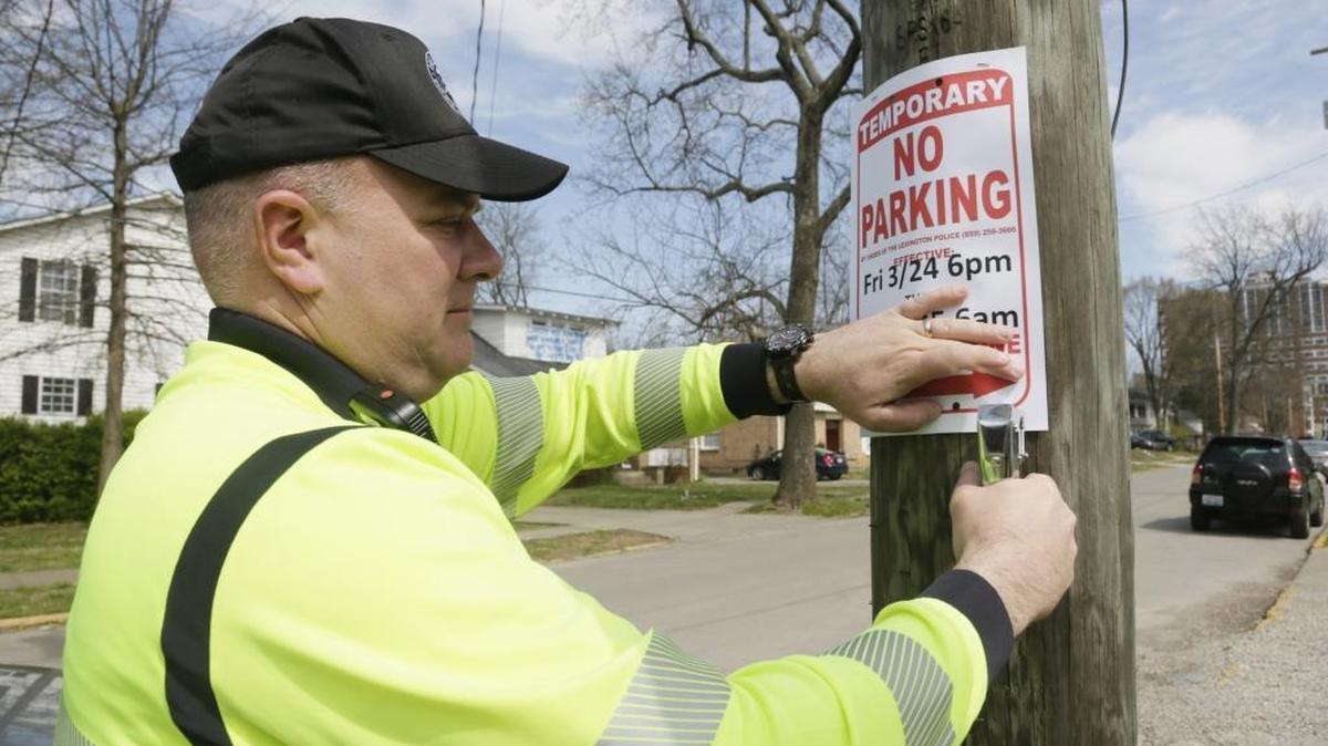 Lexington safety officer Andrew Short posted no-parking signs on State Street in March 2017.