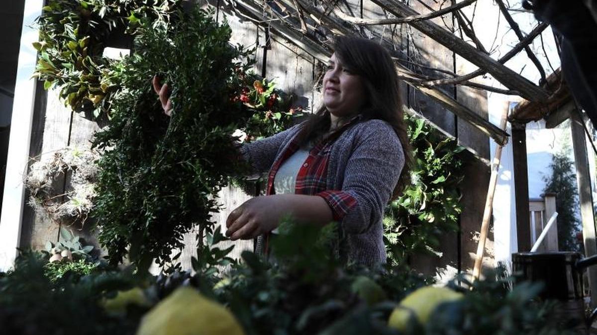 Anna Campomanes made a wreath Sunday during a German-style Christmas Market at Kentucky Native Cafe inside Michler’s Greenhouses in Lexington.