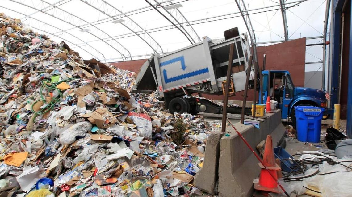 Recycling trucks unloaded into large piles to begin the sorting process at the Lexington area recycling center on Thompson Road.