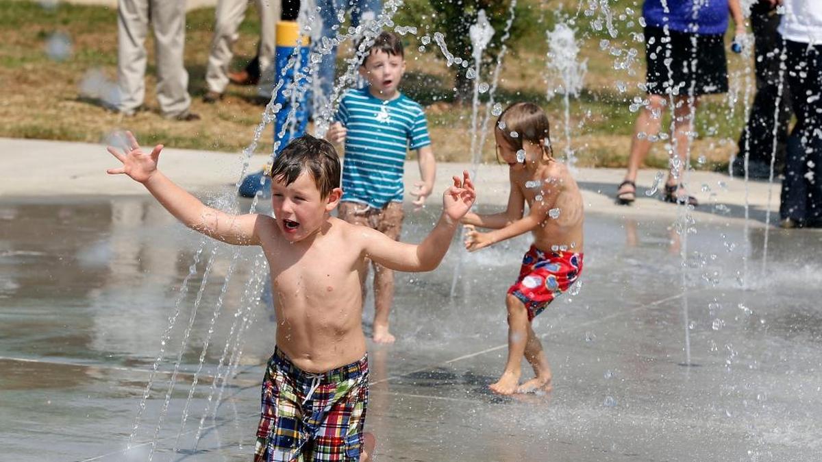 Kids, including 4-year-old Charlie Aube, front, played at Lexington's first public sprayground at Masterson Station Park in Lexington, Ky., Monday, September 18, 2017. Mayor Jim Gray, council members and Parks and Recreation officials, cut a ribbon to officially open the sprayground which is located near the park's playground.