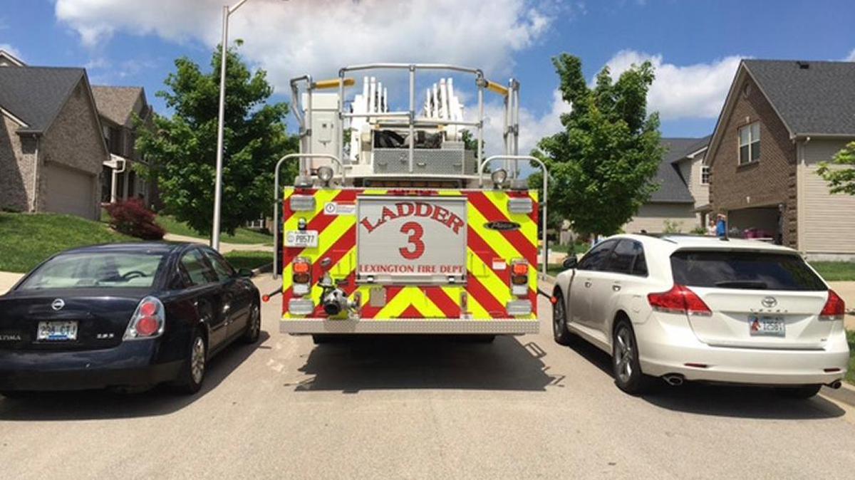 A Lexington fire truck on a 27-foot wide street in the Masterson Station neighborhood when there are cars parked on both sides. Under a proposal passed by a Lexington Council committee on Tuesday, newly-constructed streets less than 30-feet wide would have parking restricting on one side of the street.