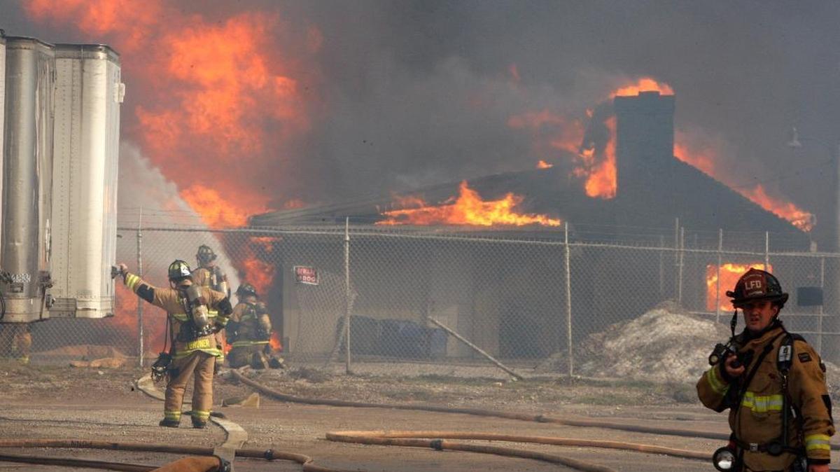 Firefighters worked the fire at Blue Grass Stockyards that spread across the road to neighboring businesses.