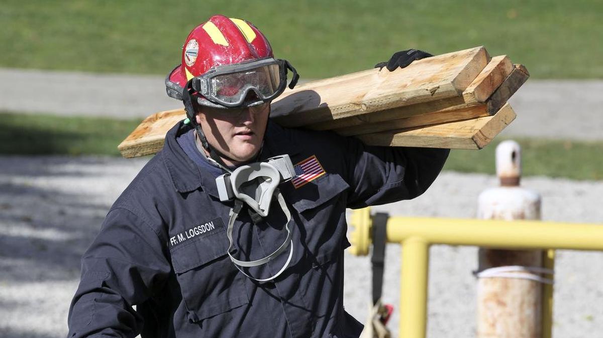 In this October 2013 file photo, Lexington firefighter Matt Logsdon carried wood to be used for shoring during a structural collapse training session at the Fire Training Center on Old Frankfort Pike in Lexington.
