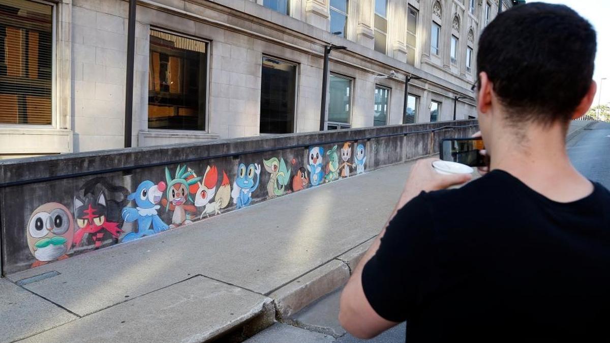 Joe Alcorn took photos Wednesday of Wylie Caudill’s chalk art on a wall on the Martin Luther King Boulevard viaduct just off East Main Street in Lexington. Artist Wylie Caudill created the Pokemon mural over the weekend.