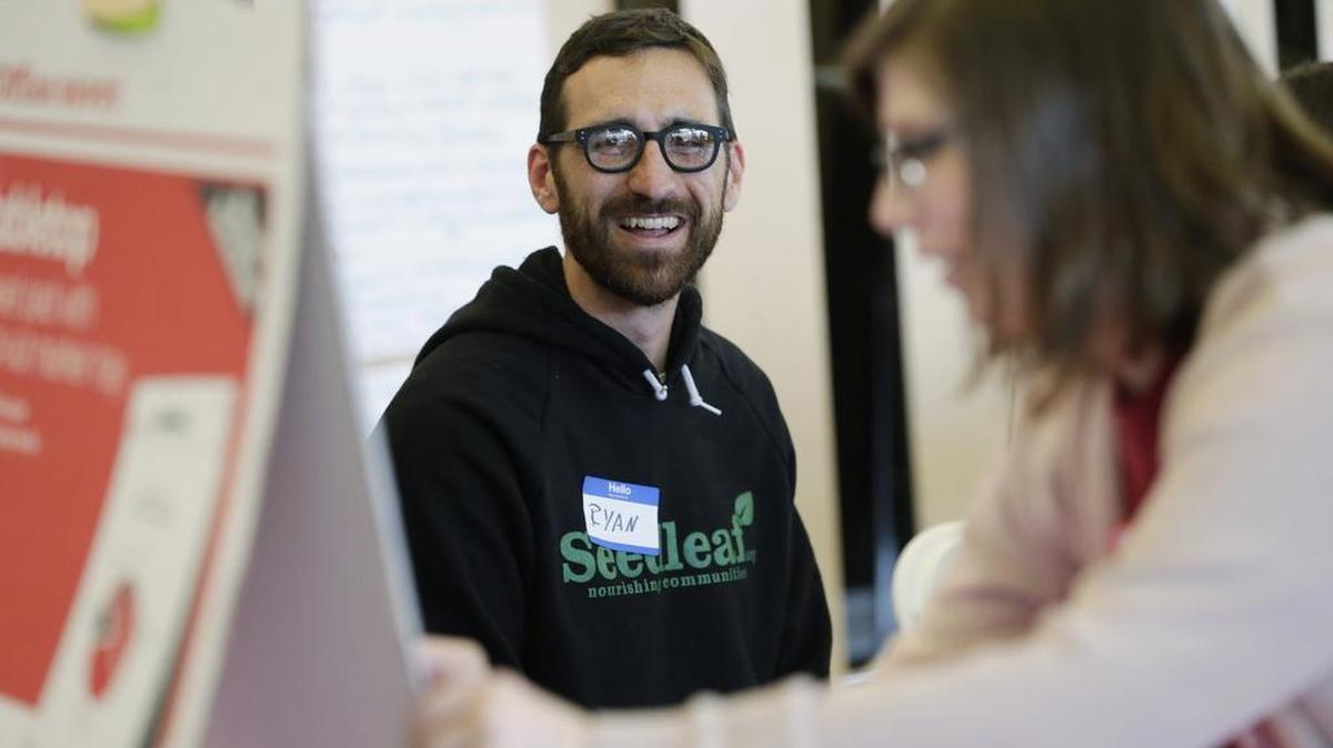 Ryan Koch, director of Seedleaf looked on as Sarah Legas Newman took notes on a tabletop easel pad during a conference on composting at Sayre School.