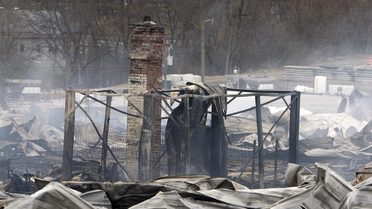 Smoldering structure in the aftermath of a massive fire at Blue Grass Stockyards that spread across the road to neighboring structures on Lisle Industrial Avenue on Jan. 31.