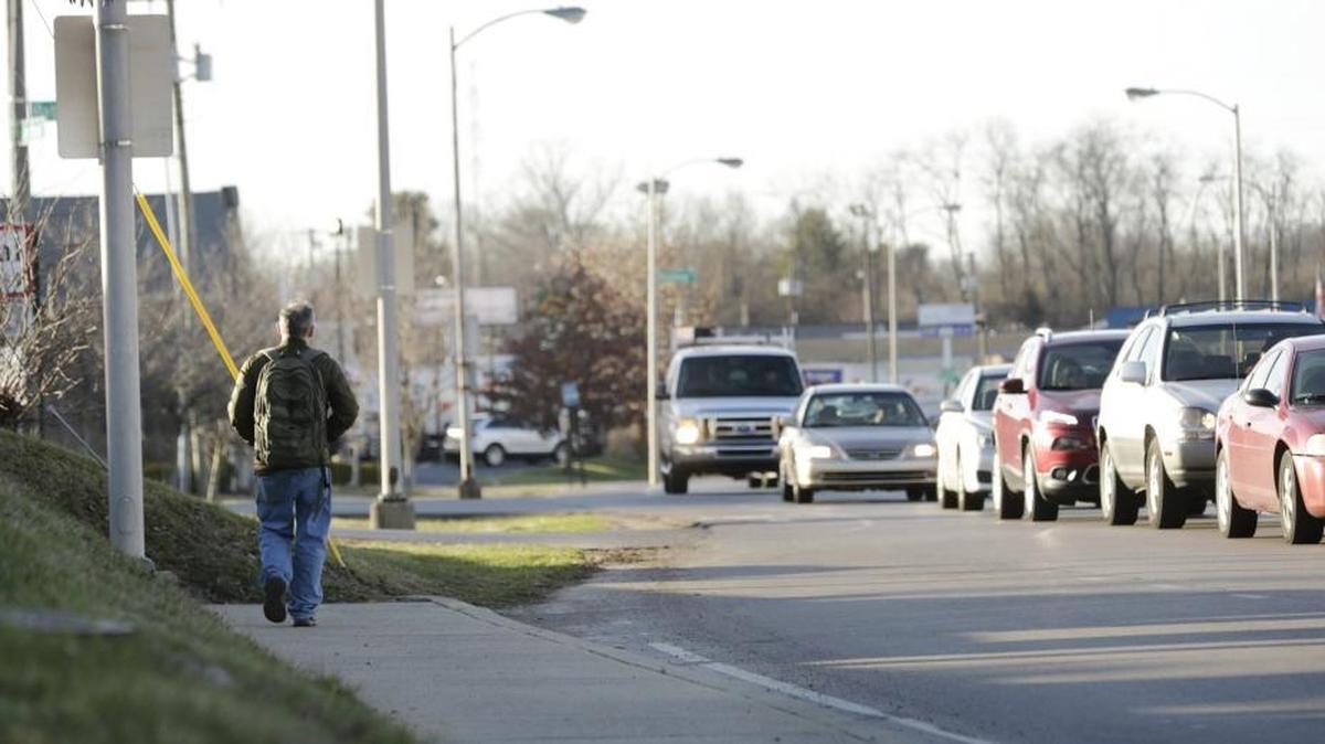 A pedestrian approached the sidewalk’s end on Southland Drive in Lexington on Feb. 16.