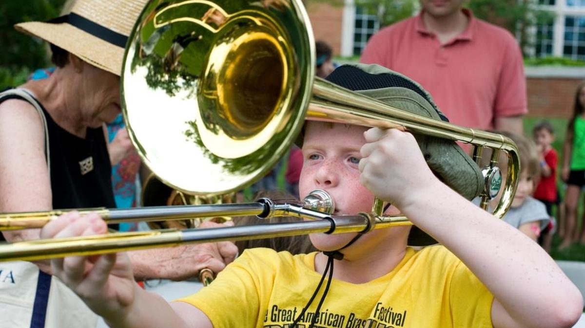Ralph Bright, 8, of Lexington, tried to play the trombone during the Great American Brass Band Festival in Danville in 2013. This year’s festival kicks off Thursday.
