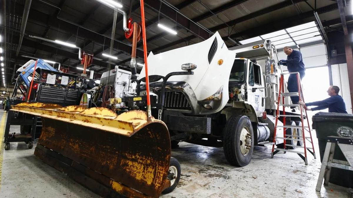 Heavy equipment technician Dallas Montfort, of Morehead, Ky., left, and heavy equipment supervisor Daniel Burns, of Mount Sterling, Ky., perform maintenance on a snowplow truck at the city's Division of Fleet Services Dept. in Lexington, Ky., Thursday, Jan. 11, 2018. A winter storm watch has been issued for the region from 7 a.m. Friday to 7 a.m. Saturday.