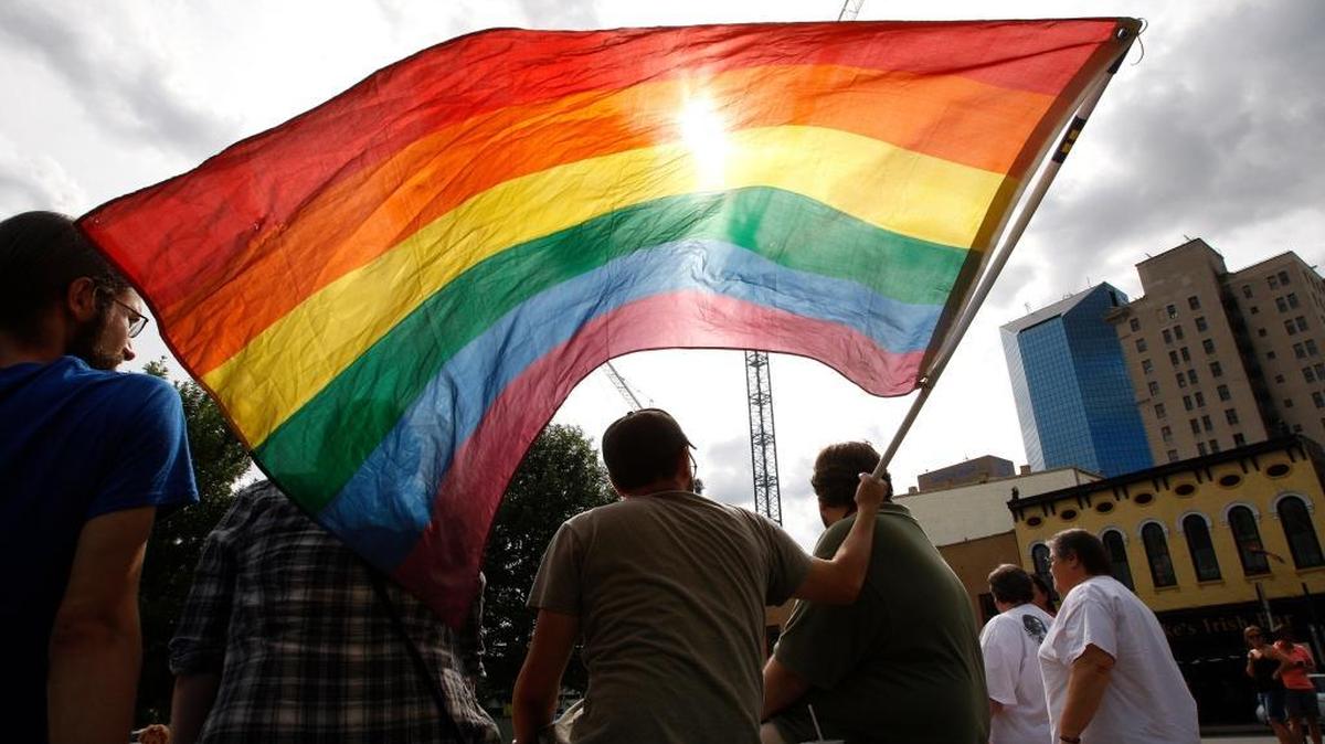 Security is being increased for Lexington’s Pride Festival on June 25. At last year’s festival, a Pride flag held by Michael Harrington of Berea was backlit by the sun during the Decision Day Rally, celebrating the marriage equality ruling. Photo by Matt Goins