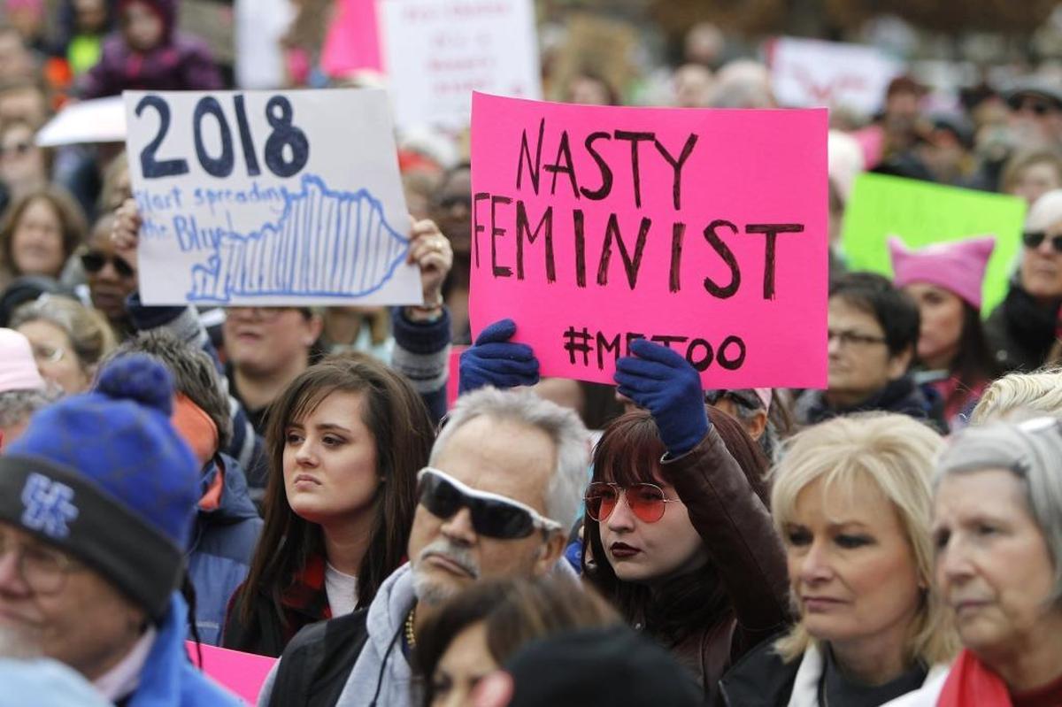 A woman held a sign during the NOW Women's March Anniversary Rally Saturday in Lexington.