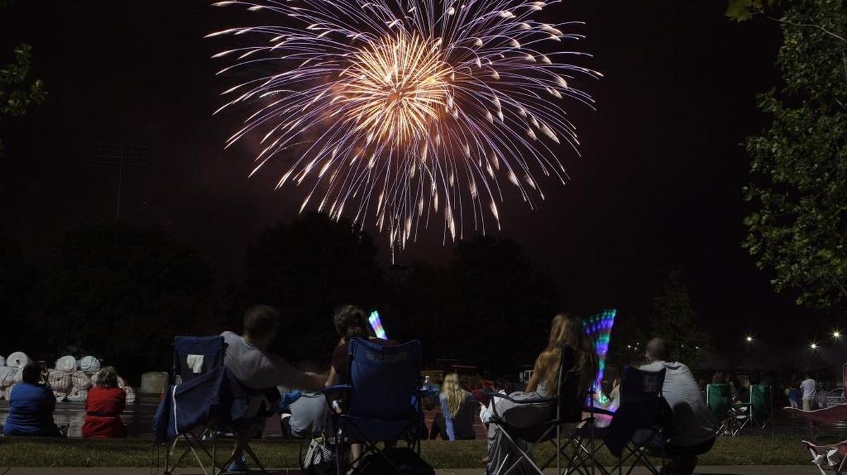 People watch the city fireworks display in the Commonwealth Stadium parking lot on the UK campus in Lexington, Ky., Monday, July 4, 2016.