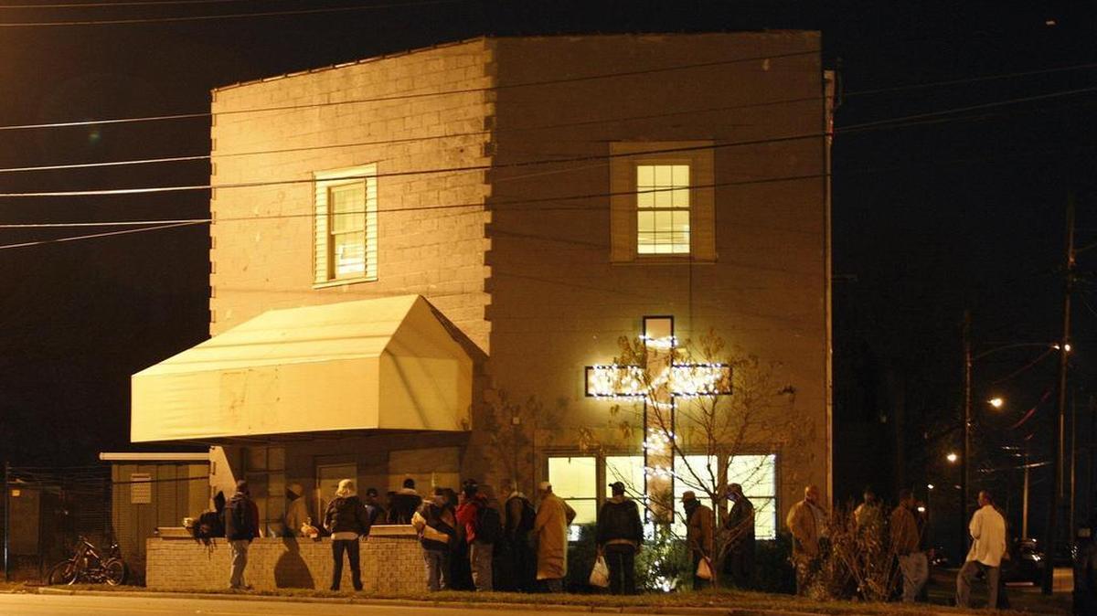 People line up as they wait to enter the Community Inn on Winchester Road in Lexington when the doors open nightly at 7 p.m.