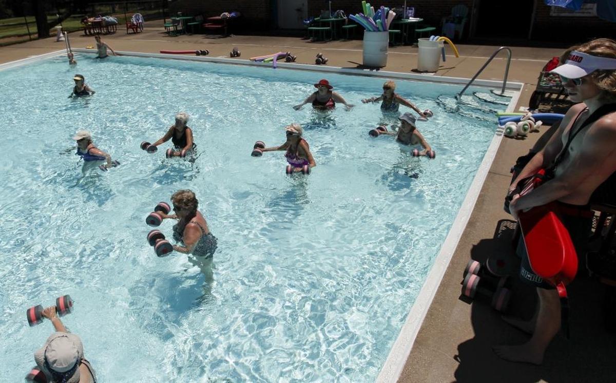 Lifeguard Thomas Priest, right, watches participants lift water foam weights during the Senior Water Aerobics class on Tuesday, June 20, 2017 at the Picadome Pool in Lexington, Ky. Mayor Linda Gorton has proposed closing the Picadome Pool as part of budget cuts. The senior water aerobics program will move to Southland pool.