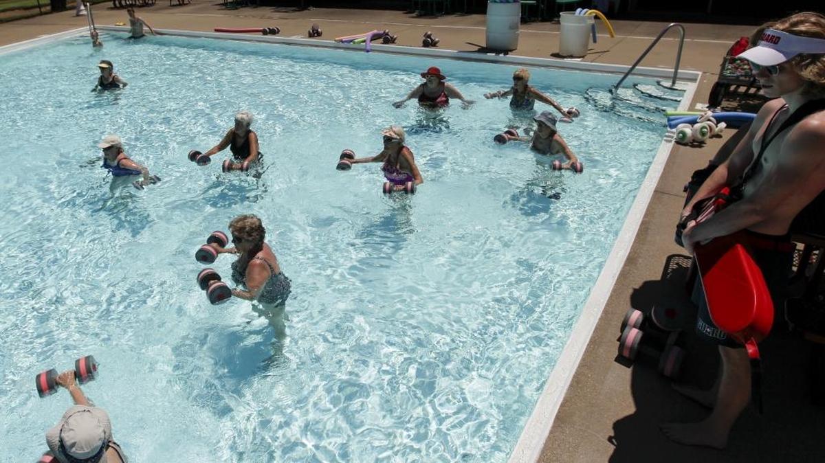 Lifeguard Thomas Priest, right, watches participants lift water foam weights during the Senior Water Aerobics class on Tuesday, June 20, 2017 at the Picadome Pool in Lexington, Ky. Mayor Linda Gorton has proposed closing the Picadome Pool as part of budget cuts. The senior water aerobics program will move to Southland pool.