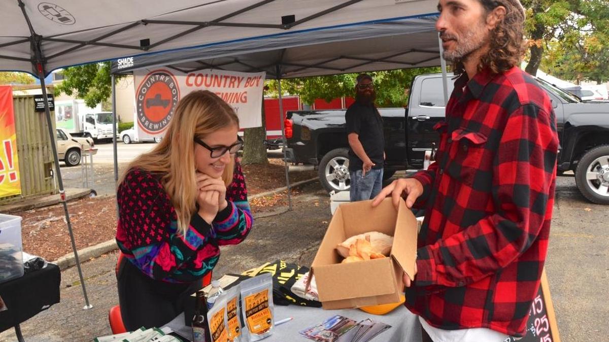 Nico Meredith admired mushrooms that Matt Wegner brought to the Veg Fest. The box held shiitake mushrooms grown on Wegner’s farm near Berea, and also “chicken of the woods” mushrooms picked in the woods. Meredith is an associate with Louisville Vegan Jerky Co.