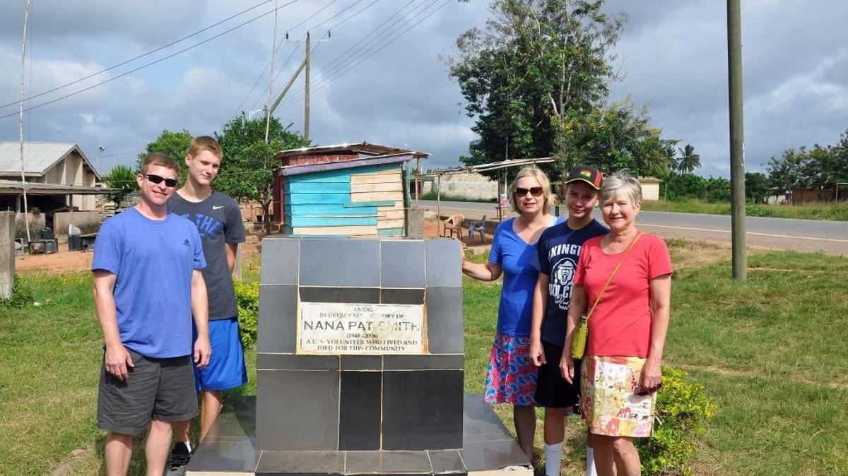 Brian Smith, left, his son, Jackson, his sister, Jennifer Combs, her son, Wyatt, and their mother and grandmother, Jean Smith, stand in front of a memorial erected to Pat Smith in the village of Asasan, Ghana, after he died aboard Comair flight 5191. Village elders had given him the title “sub chief for development”. The word "Nana" on the monument means "chief" and the inscription calls Smith "A U.S. volunteer who lived and died for this community."