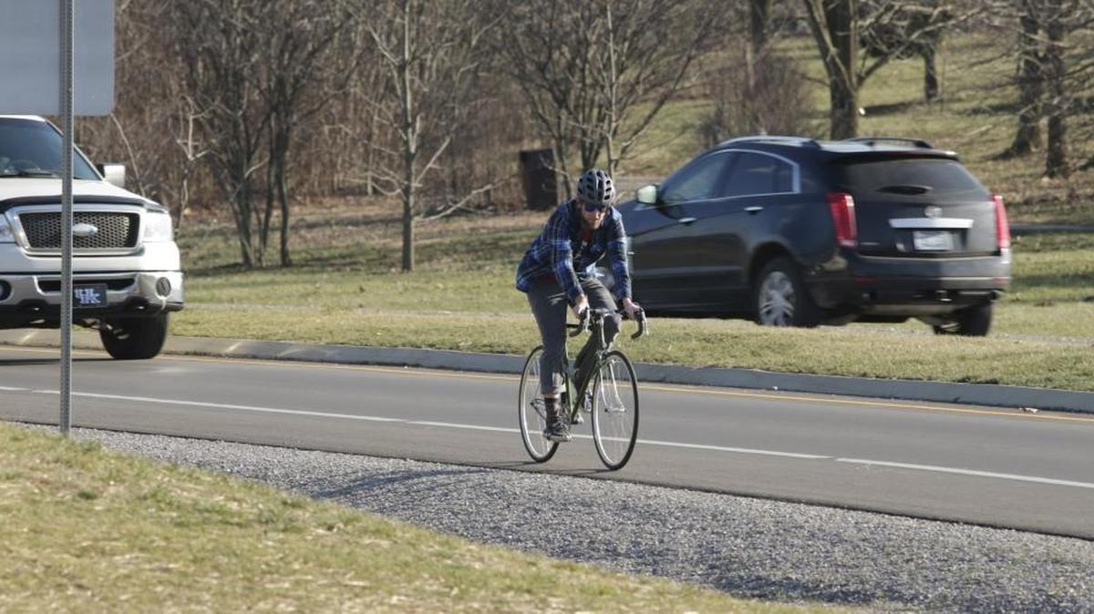 A cyclist rode in the bike lane on Alumni Drive in Lexington on Jan. 14. The city has a federal grant to interconnect its bike trails and bike lanes.