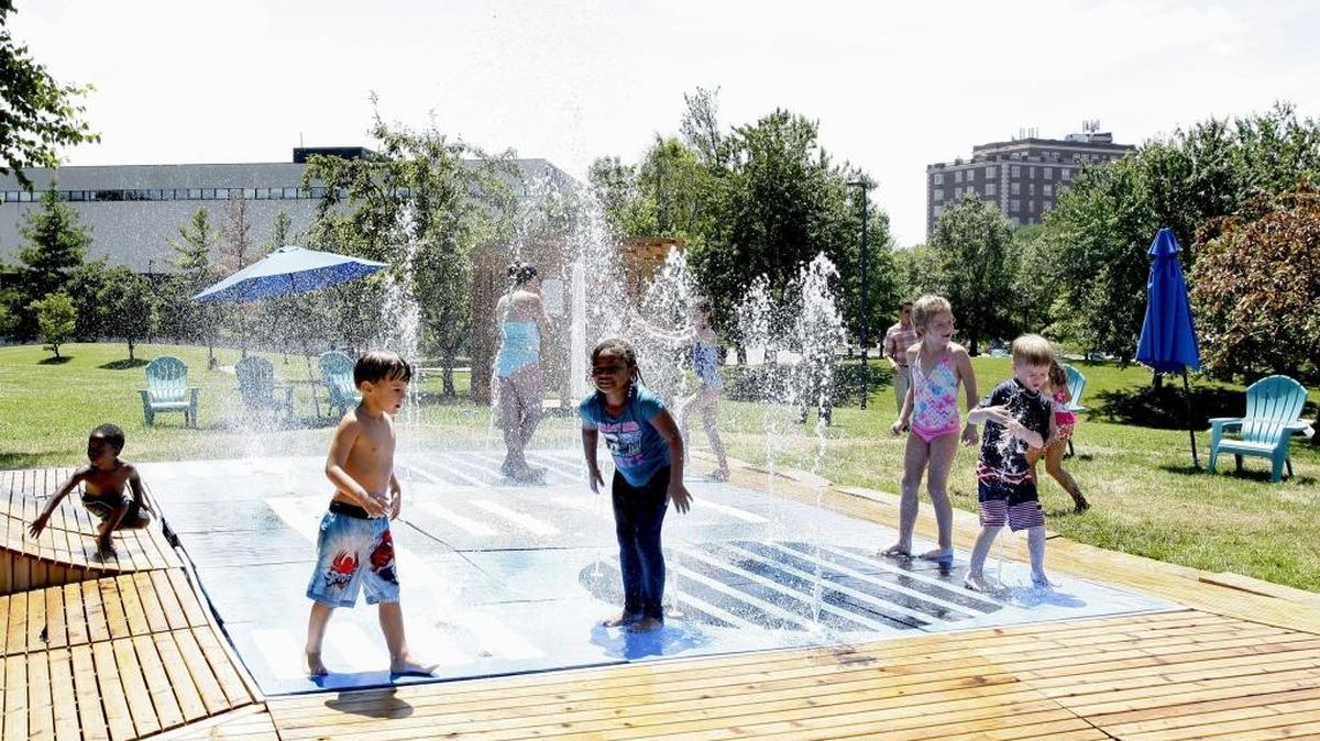Children gathered at Northeastern Park to enjoy the opening of the new temporary splash park.