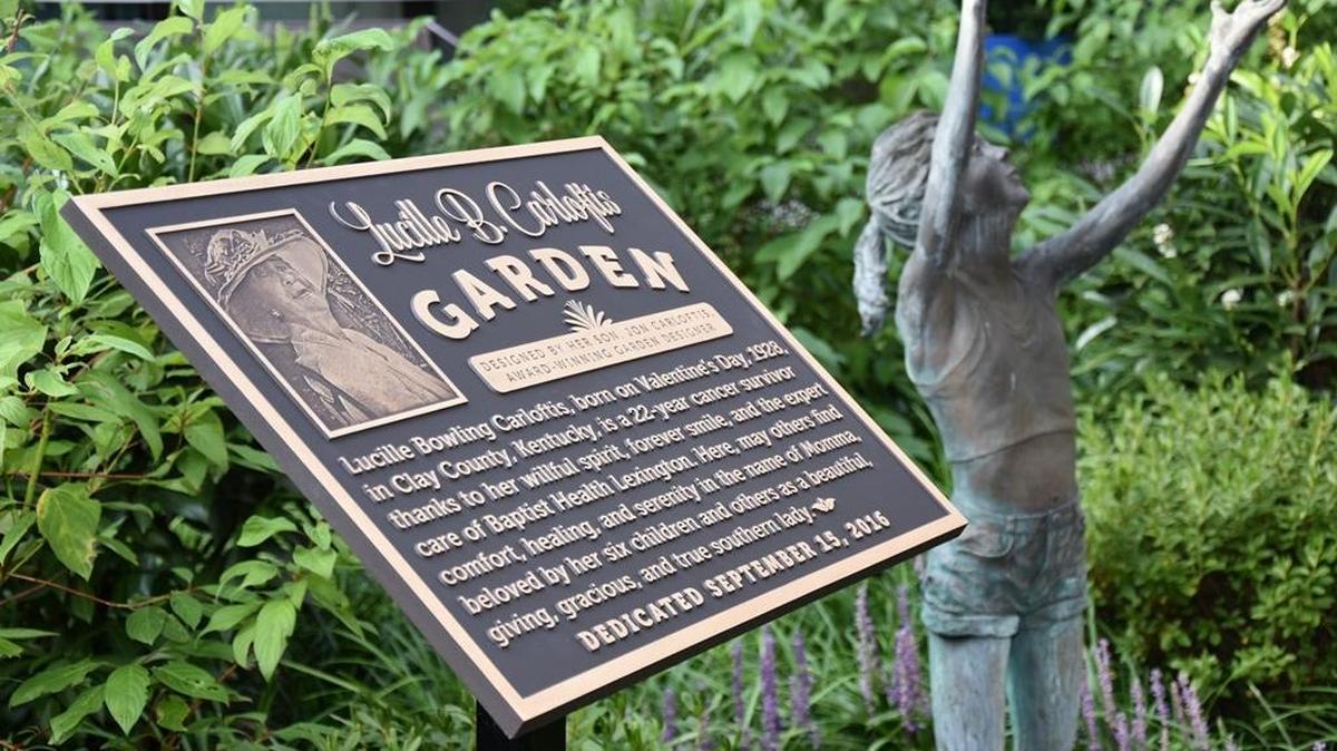 The plaque in the garden at the Baptist Health Lexington Cancer Center mentions Lucille Bowling Carloftis’ “willful spirit” and expresses hope that “others find comfort, healing and serenity” in her name.