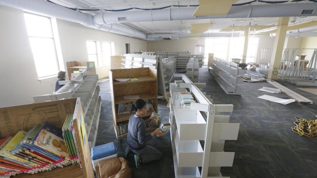 Alison Weber, left and Yvonne Hwang stacked children's books at the new Eastside Library on Blake James Dr. in Lexington, Ky, on March 2, 2016. The new branch of the Lexington Public Library is scheduled to open March 16th.