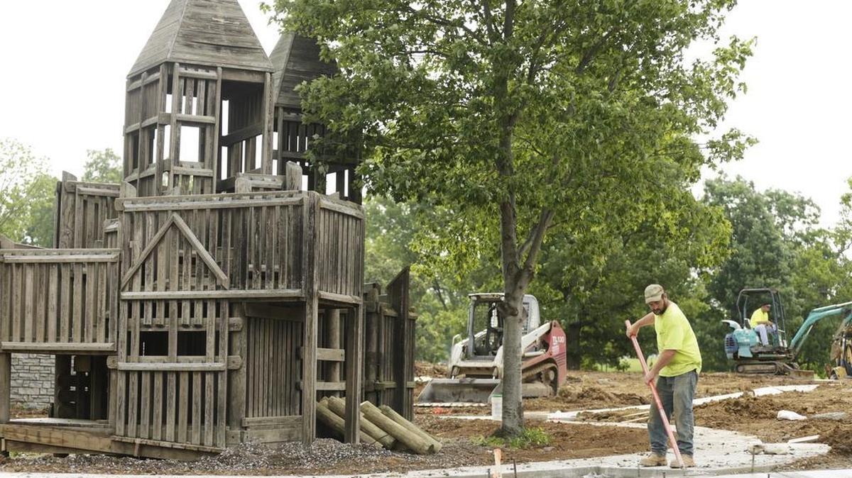 David McIntosh worked on a sidewalk near a preserved section of wooden playground at Jacobson Park in Lexington, Ky, on June 23, 2016. The nearly complete playground replaces a wooden playground built in 1993.