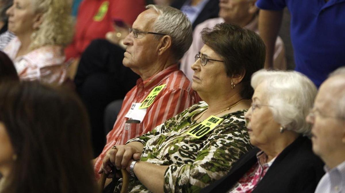 Members of the Meadowthorpe Neighborhood Association wore stickers to express their disapproval of Republic Services application to install a garbage transfer station on Lisle Industrial Ave. during a meeting of the city's Board of Adjustment in council chambers at the Government Center in Lexington, Ky., Friday, April 29, 2016.
