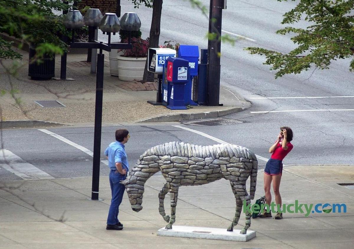 A couple snapped photos of each other next to the Horse Mania horse “Stonewall” on July 27, 2000, at Main and Mill streets in Lexington. The popular public arts project featured 79 horses on display throughout Lexington. Sponsors paid $1,200 for each horse frame and $2,500 for an artist to design the horse. They were then put out for display from July through November 2000. In December, they were auctioned off, generating $750,000 for Lexington Arts and Cultural Council and other causes. “Stonewall” sold for the highest bid: $53,000. Another Horse Mania was launched in 2010 because of the success in 2000. Photo by | staff