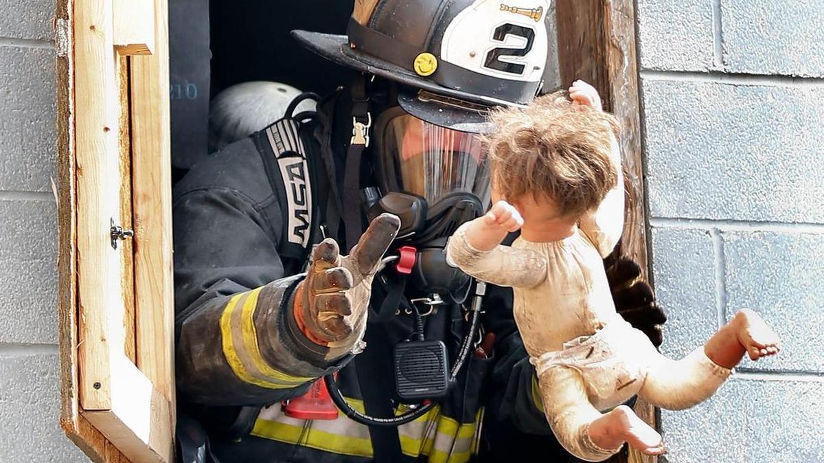 Jake Warren, an instructor with the Hendron F.D. caught a baby mannequin tossed to him during a "ladder Ops" class at 87th Annual Kentucky State Fire School at the Lexington Fire Dept. Training Center on Old Frankfort Pike in Lexington, Ky., Friday, June 3, 2016. This baby mannequin was hidden on the second floor and the firefighters had to search for her. The fire school started Tuesday and runs thru Sunday June 5. This class, led by lead instructor Arthur Ashley, a Capt. with the Lex. Fire Dept, taught ladder truck rescues, how to search for victims, ventilation techniques, and forcible entry and other skills. 22 instructors, from Lexington and various states, were used to teach the 40 firefighters in this class.