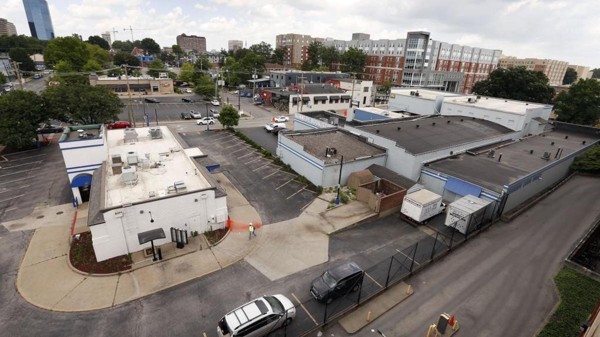 The old Fazoli’s restaurant, left, and Kennedy Book Store, right, on Winslow Street will be developed into retail and parking by UK.
