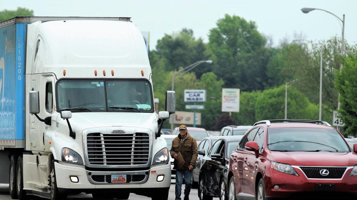 A panhandler walked between lanes of traffic at the intersection of North Broadway and New Circle Road in Lexington on April 29, 2017.