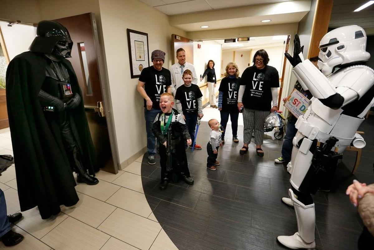 Bruce Incorporated, 5-years-old and wearing a Darth Vader costume, was surprised by Darth Vader, left, and a Storm Trooper, right, after he finished his last treatment at the University of Kentucky Markey Cancer Center in Lexington, Ky., Tuesday, January 30, 2018. Bruce received his last radiation treatment for a form of aggressive incurable brain cancer called diffuse intrinsic pontine glioma, DIPG. He is a huge fan of Star Wars and following his treatment was greeted by members of the 501st Legion, a Star Wars costuming group, as he rang the ceremonial bell marking the end of his treatment. The Star Wars characters also escorted him to a small party held in his honor. Behind Bruce was his family.