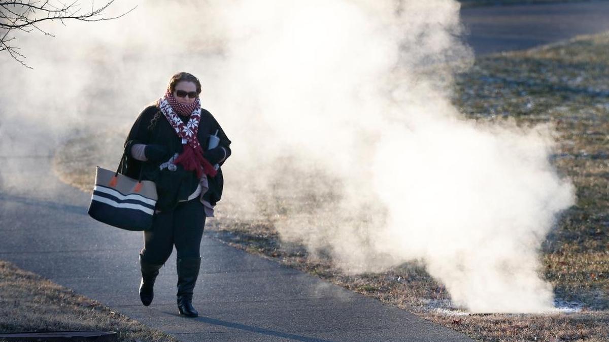 UK employee Rachael Deel walked to work Tuesday in minus-one degree temperature past a column of steam from an in-ground vent on the University of Kentucky campus. Another arctic front was expected Tuesday night, bringing temperatures in the single digits and wind chills below zero through the end of the week.
