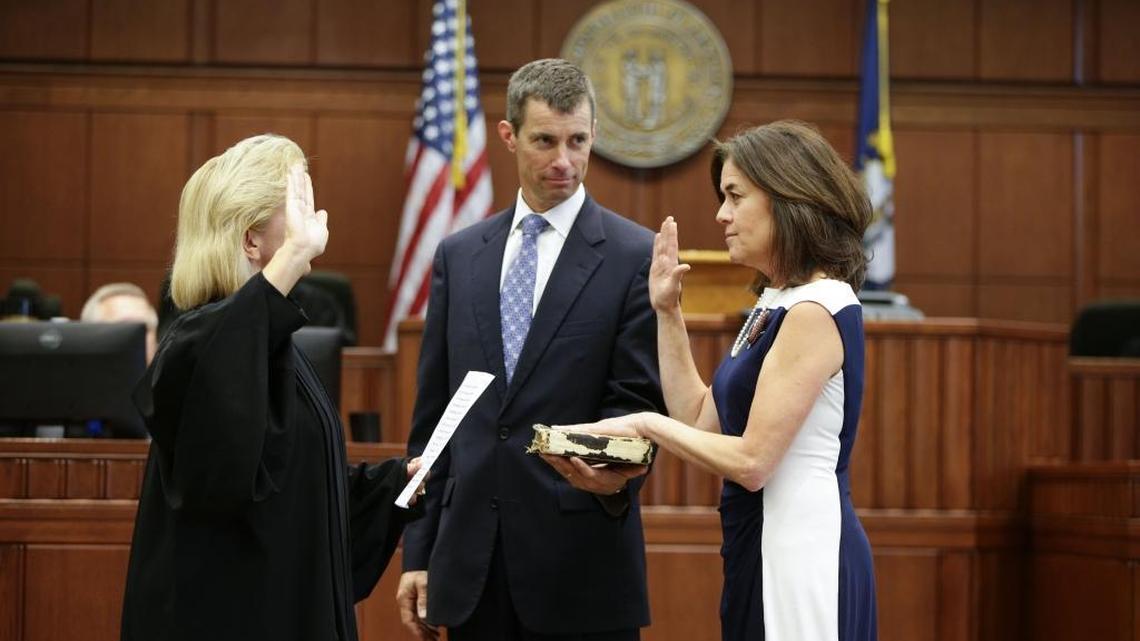 Lou Anna Red Corn was sworn in as Fayette Commonwealth Attorney by judge Kimberly Bunnell, as her husband Luke Morgan, held the bible on Monday October 3, 2016 in Lexington, Ky.