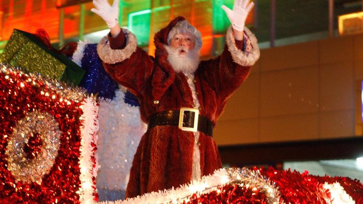 Santa Claus waved to the crowd during last year’s Christmas Parade in downtown Lexington.