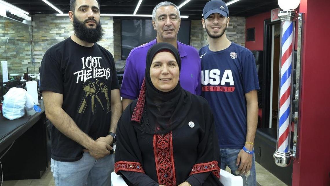 Hanan Froukh with her husband, Ayman, and two of their three sons: Fouad, left, who owns Cuts on Lime barber shop, and Ziad, a recent STEAM Academy graduate now enrolled at the University of Kentucky. A third son, Abdallah, is in Ramallah, a Palestinian city near Jerusalem, studying dessert-making so he and his father can open a Lexington bakery specializing in Middle Eastern sweets.