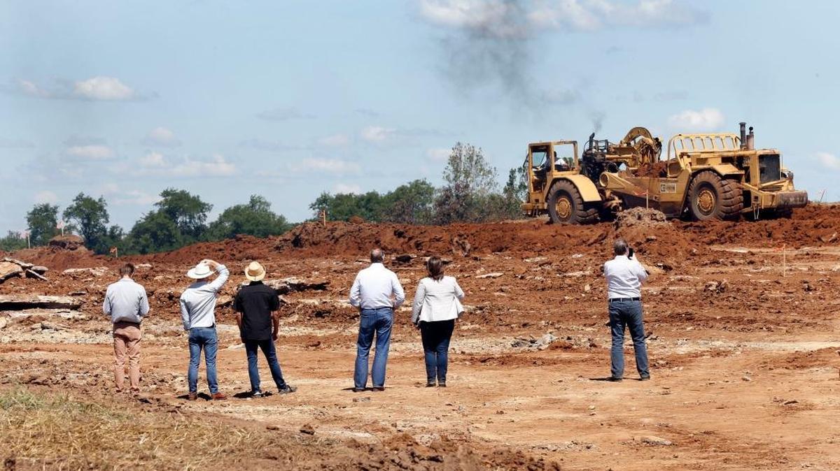 Excavation work continued during and after the ceremonial groundbreaking ceremony Friday for the new Blue Grass Stockyards at 4561 Iron Works Pike in Lexington.