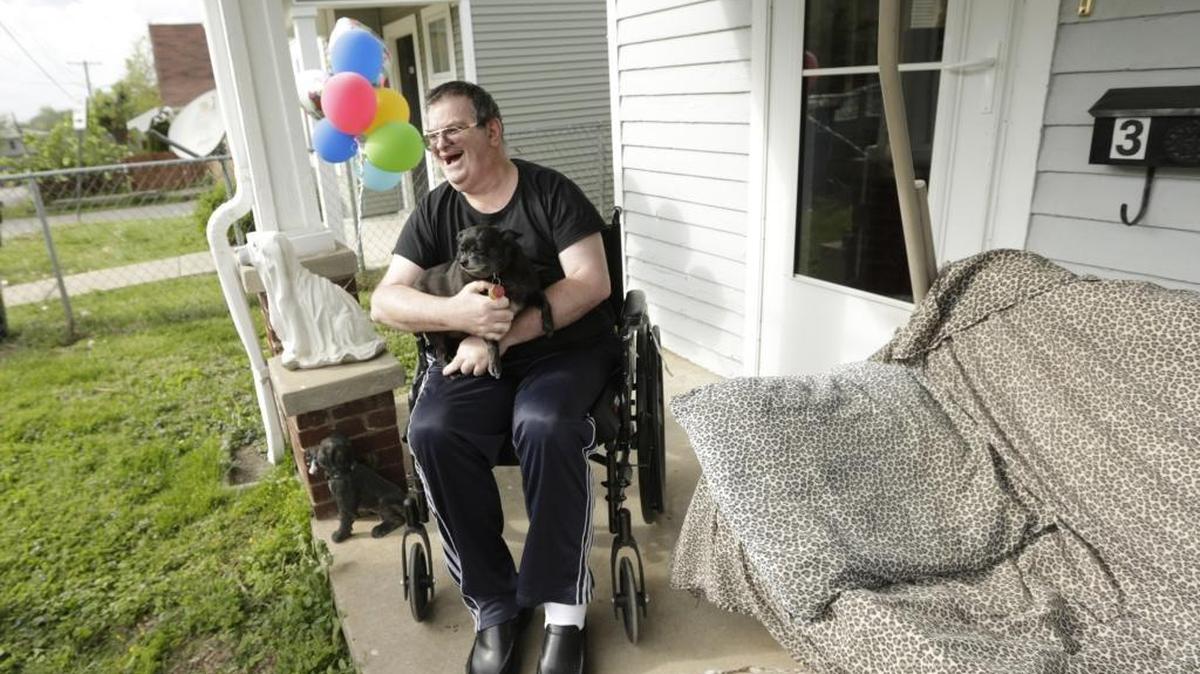 Jerry Ginter smiled as he held his dog Starrboy at his home in Lexington, Ky, on April 21, 2016. Jerry Ginter who has cerebral palsy was discharged from Northpoint Healthcare Center after a year long recovery from a series of illnesses.