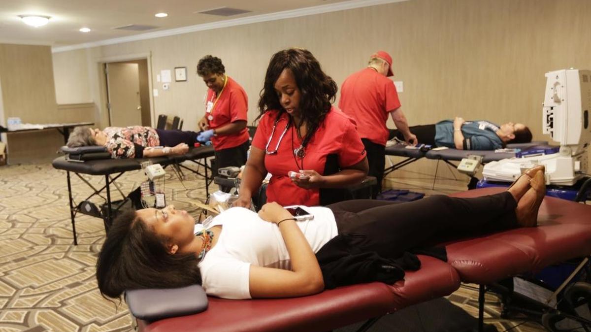 Phlebotomist DeShannon Freeman prepped blood donor Whitney Sandusky during an American Red Cross blood drive at the Campbell House in Lexington, Ky, on July 8, 2016. The blood drive was in honor of the victims of the Comair Flight 5191crash nearly 10 years ago.