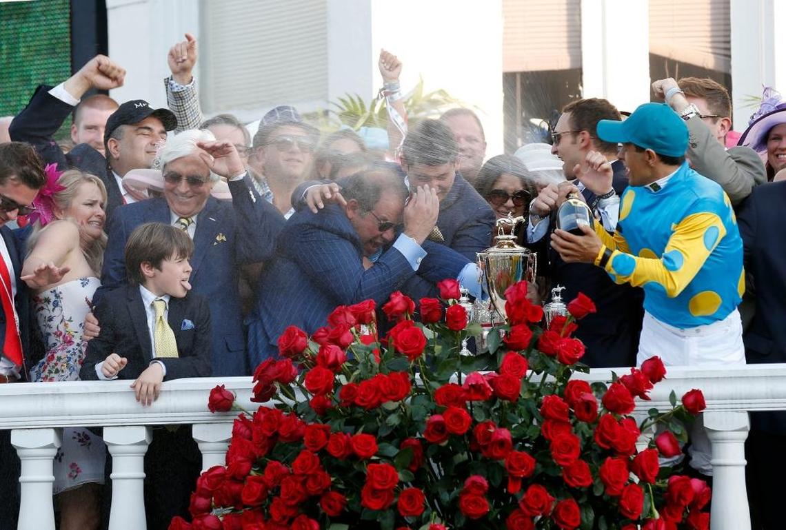 Jockey Victor Espinoza sprayed champagne on the connections of Kentucky Derby winner American Pharaoh after winning the race aboard American Pharoah. Ahmed Zayat is at center. American Pharoah would go on to win the Triple Crown.