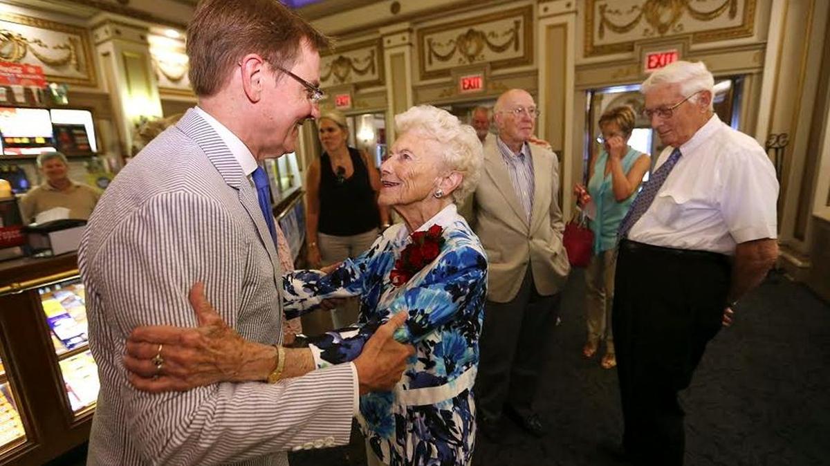Mayor Jim Gray talked with former Vice Mayor Isabel Yates on Thursday before a dedication of a plaque honoring Yates for her leadership in the restoration of the Kentucky Theatre.