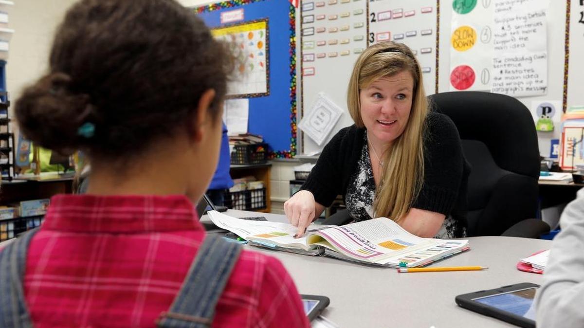 Third-grade teacher Jennifer Exterkamp with her class at Picadome Elementary in Lexington. After suffering a stroke about a year ago, she has become an advocate for heart health.